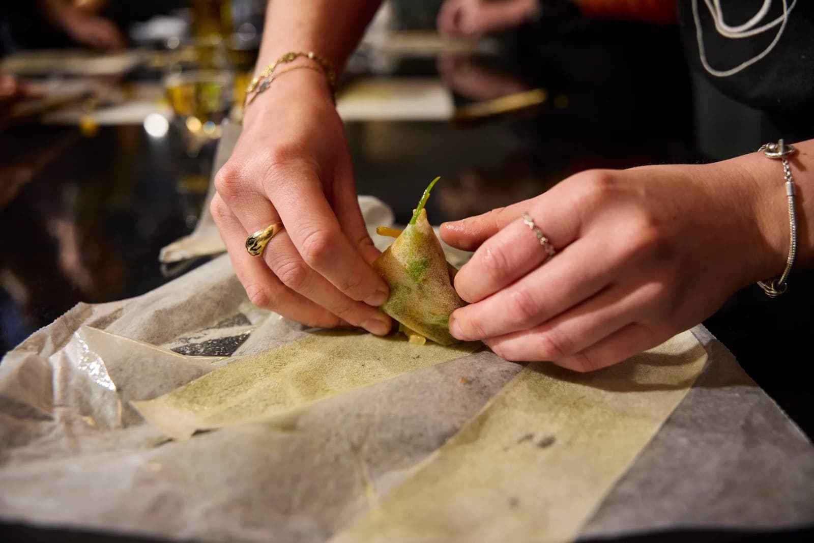 The chef's hands closing a papillote during a Classique cooking class, Paris 11